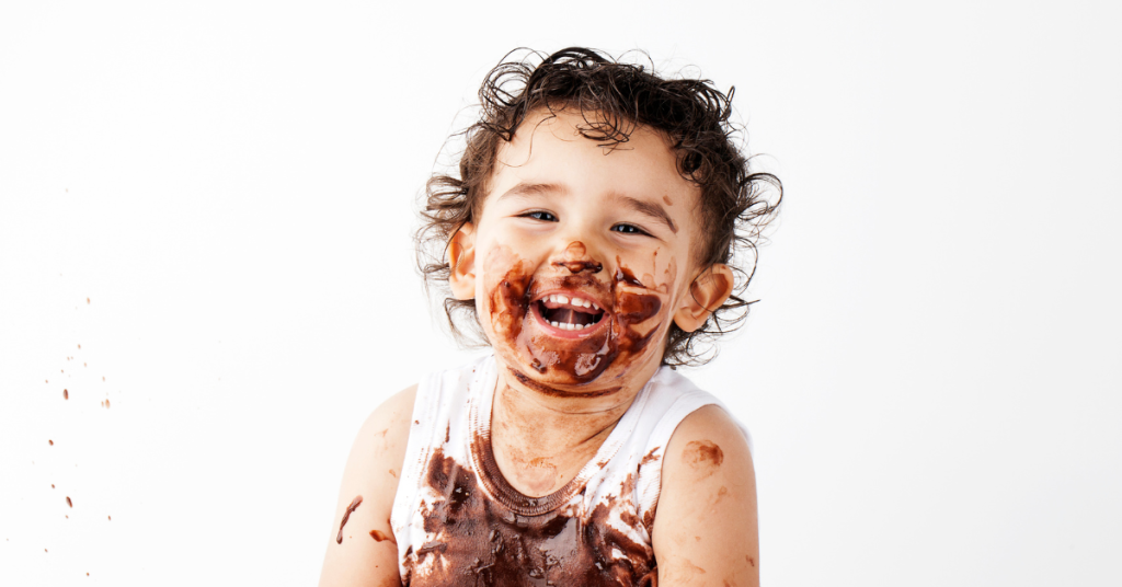 laughing child eating chocolate