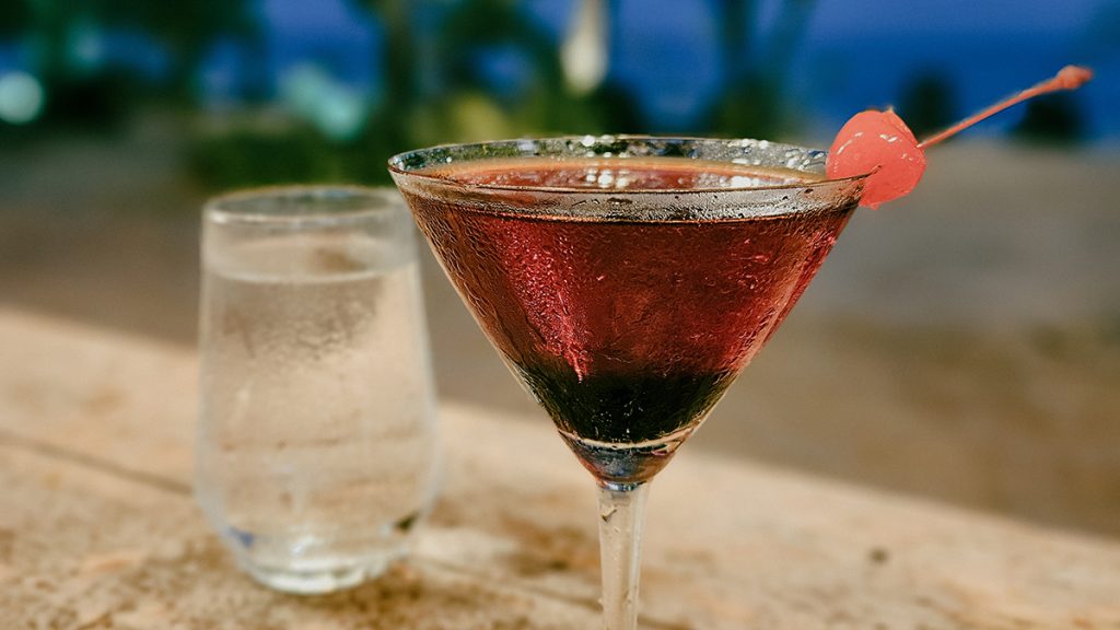 Close-Up of a Cocktail Against a Beach Backdrop